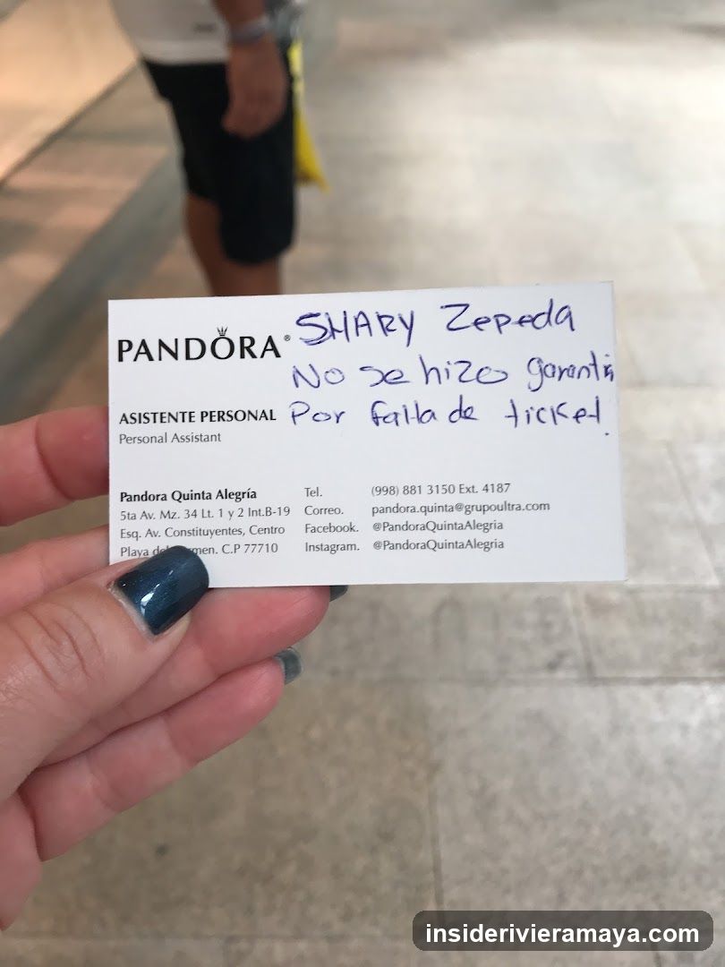 Hand holding a business card with handwritten note
