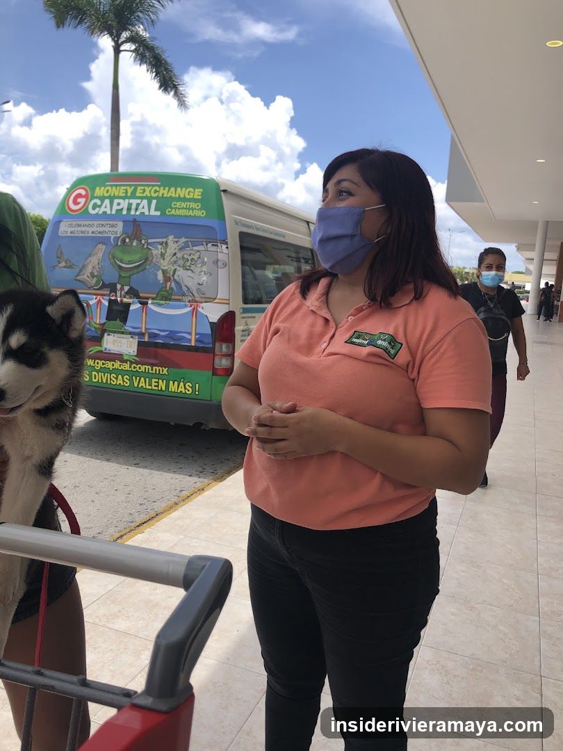 Woman in uniform with dog and bus