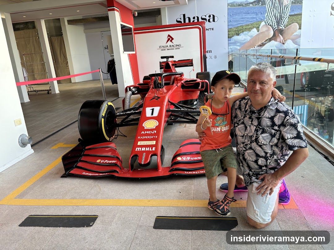 Man and child posing with Formula 1 car