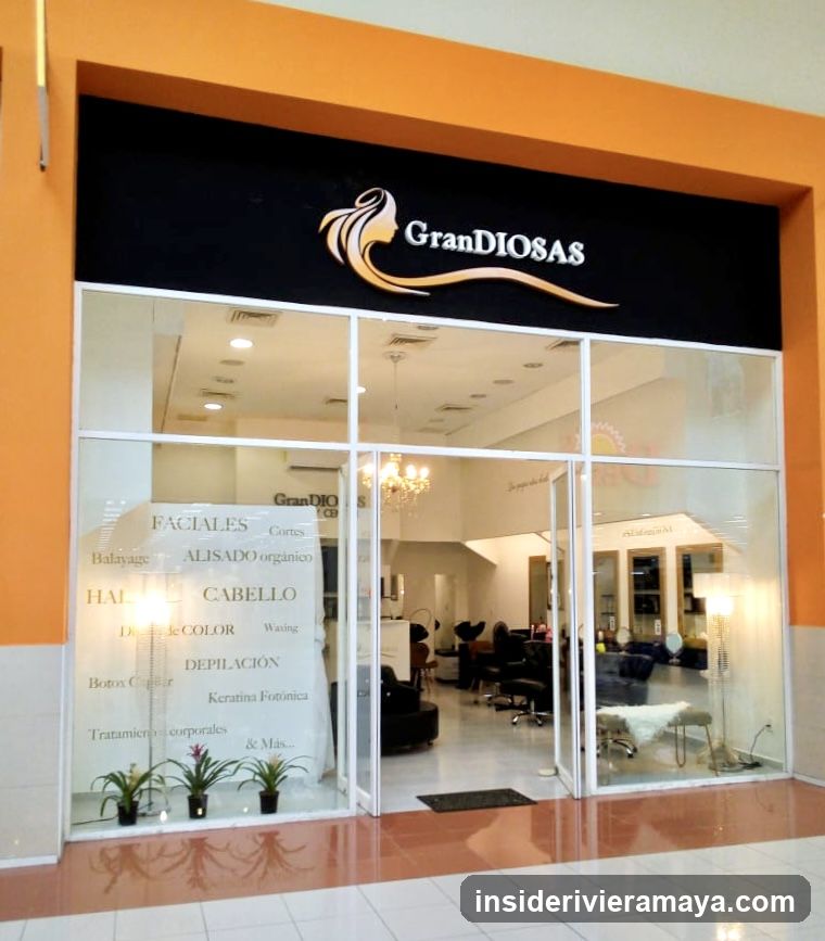 A storefront with an orange facade and a black sign reading 'GranDIOSAS' in white text with a gold hair swirl logo. Large glass windows display a list of services including FACIALES, ALISADO, CABELLO, DEPILACIÓN, and Botox. Inside, salon chairs and lighting fixtures are visible.