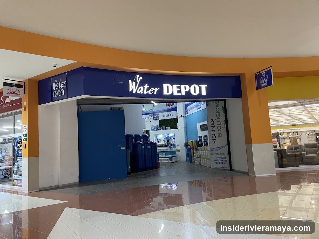 A view of a retail store entrance located within a shopping mall corridor. The storefront features a prominent blue fascia with the white text 'Water DEPOT' and a logo. The entrance is open, revealing a blue door to the left and various merchandise inside, including large blue water containers and pool-related items. A vertical banner advertising 'PISCINAS ECOLOGICAS' stands near the entrance. The floor is tiled and reflective.