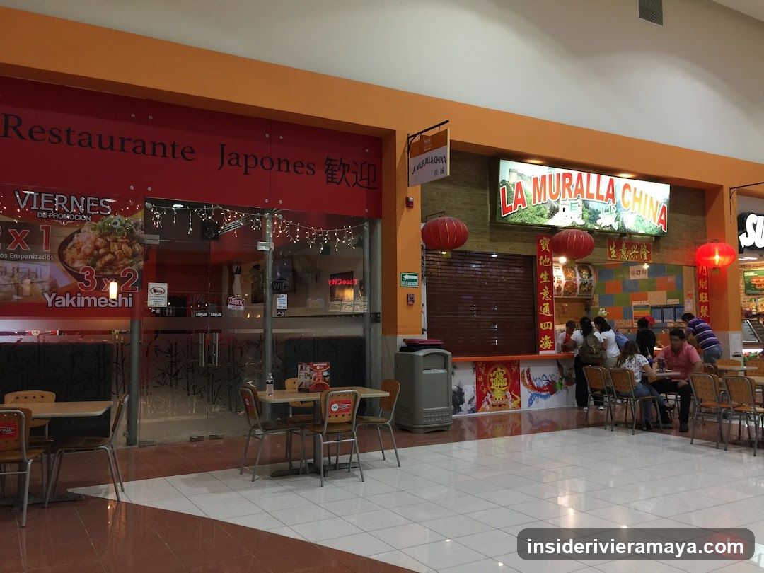 A view of a food court inside a shopping mall featuring two adjacent restaurants. On the left is a Japanese restaurant with a red facade and a large poster advertising a 'Viernes de Yakimeshi' deal. On the right is a Chinese restaurant named 'La Muralla China', decorated with red lanterns and vertical banners. Several customers are seated at tables eating in the foreground.